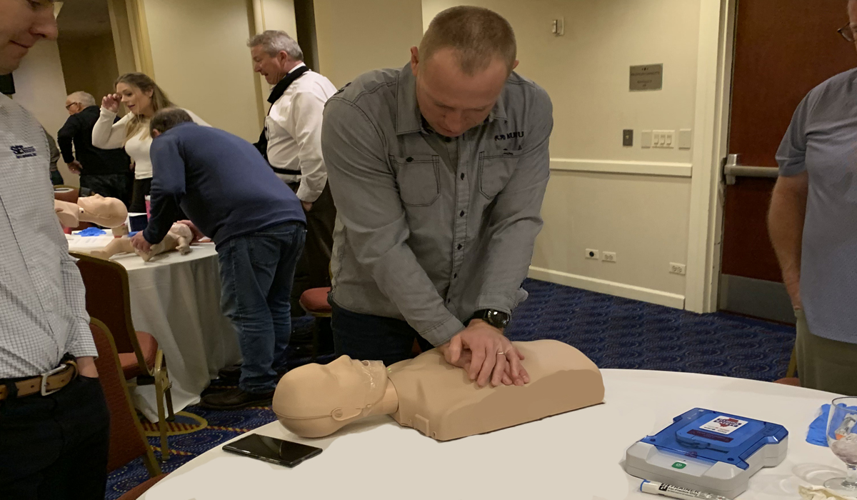 man performing CPR on a CPR doll