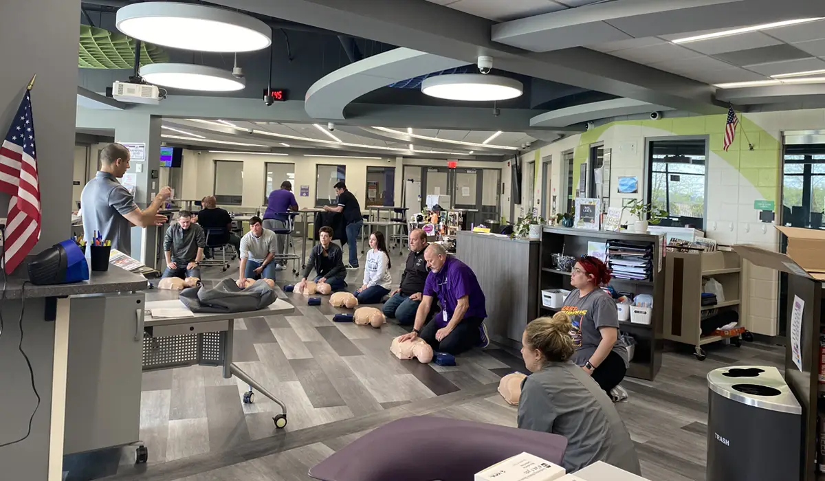 Employees in an office room training in CPR.