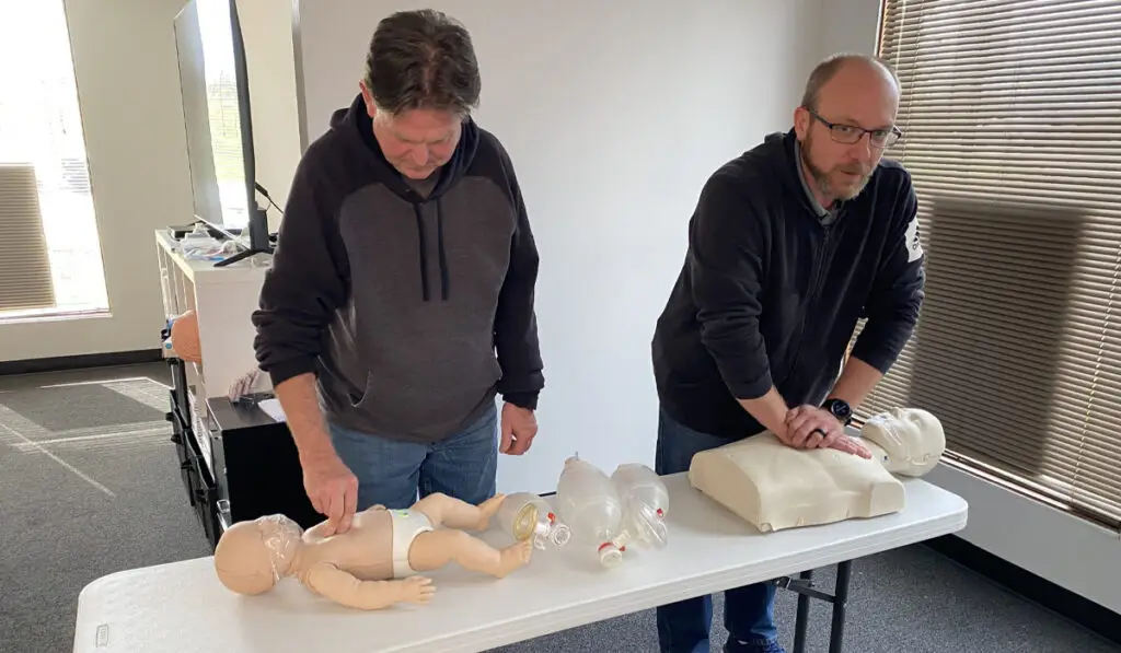 two men training in CPR