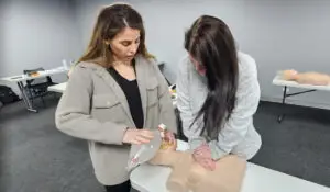 Women training in CPR using a CPR doll.