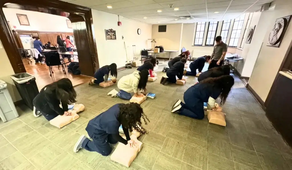 Healthcare professionals practicing CPR skills during an ACLS and BLS Combined Certification course at Illinois Safety.