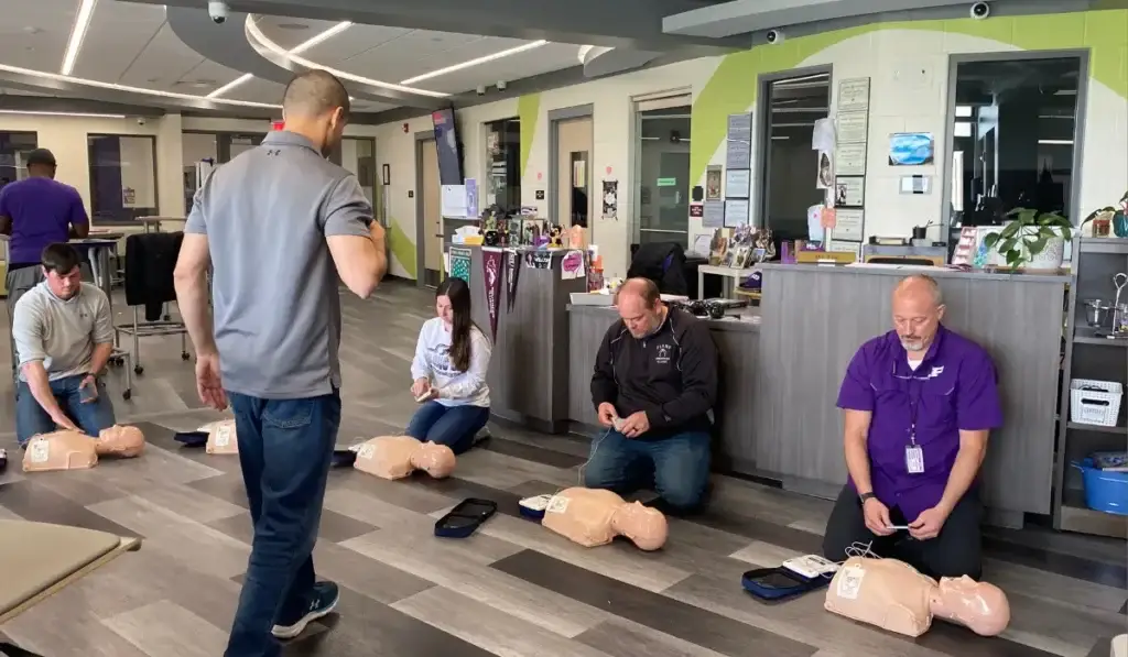 Healthcare professionals practicing CPR techniques during an ACLS Certification class in Chicago