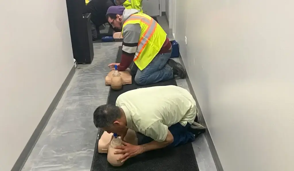 Participants practicing CPR techniques during a BLS certification class at Illinois Safety in Chicago.