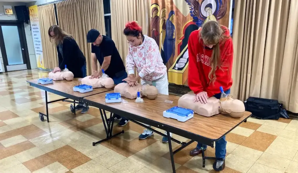 Participants practicing chest compressions during a hands-on CPR training class in Chicago with certified instructors.