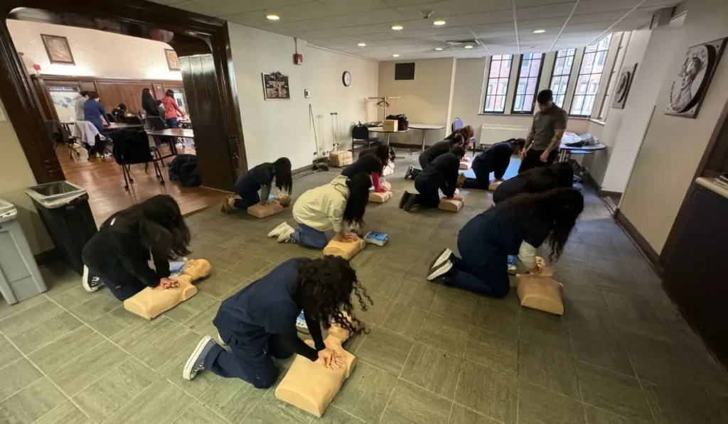 Healthcare professionals practicing CPR on manikins during ACLS renewal class in Chicago with instructor guidance.