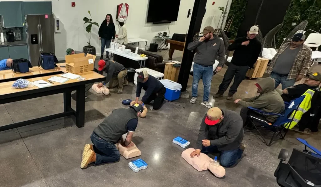 Hands-on CPR training with adult manikins during a Life Support Certification class led by Illinois-based emergency responders.