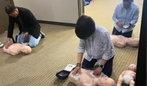 Healthcare professionals completing BSL Recertification Chicago hands-on AED and CPR skills assessment during renewal training.