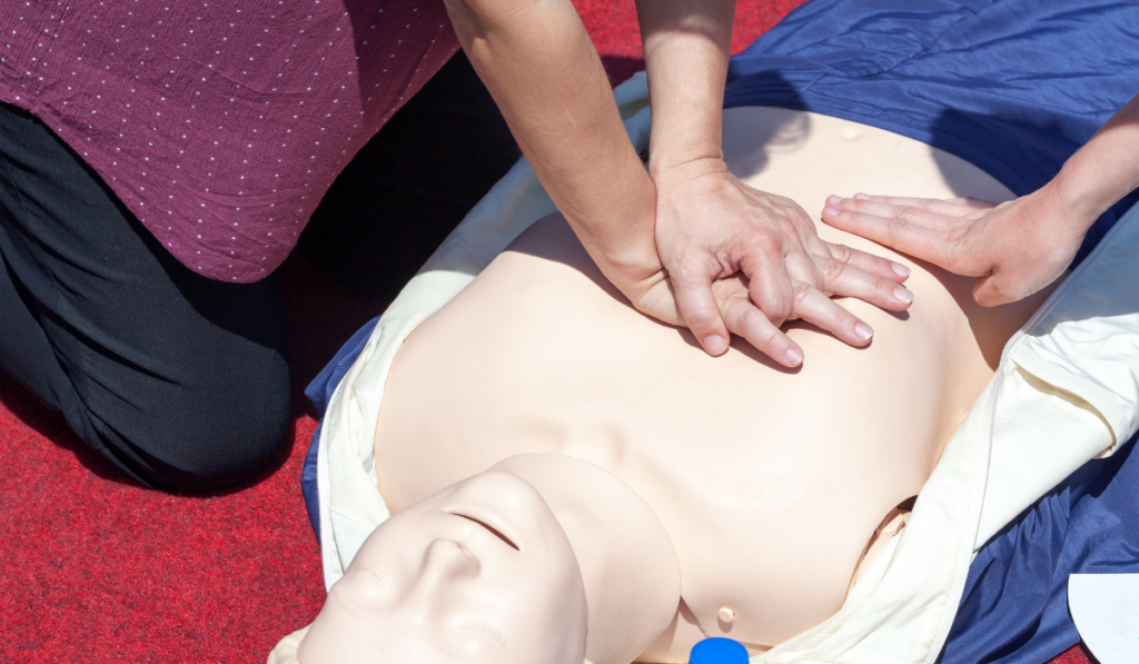 Hands performing chest compressions during CPR training, demonstrating CPR training tips for travelers responding to a collapse emergency